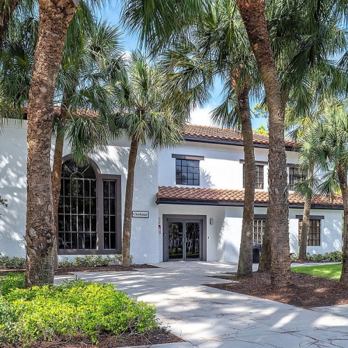 24-Hr Fitness clubhouse exterior surrounded by palm trees