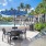 grilling area and umbrella shaded table with chairs