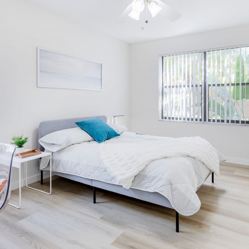2nd Bedroom ceiling fan and light fixture in bedroom with large windows